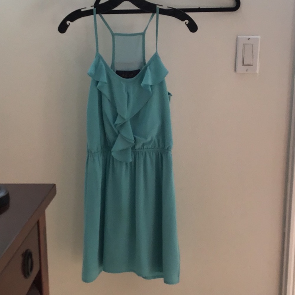 Beautiful short blue dress with ruffle detailing.